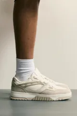 Zapatillas de basket para hombre en color tostado, con diseño de paneles en tonos beige y blanco, cordones al tono y suela chunky de goma.