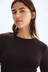 Remera de manga larga confeccionada en microfibra suave, con corte entallado y escote redondo con ribete.