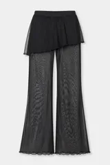 Pantalón de pierna ancha con sobrepollera integrada de tul semitransparente, confeccionado en tela negra liviana. Presenta un diseño de doble capa que aporta movimiento y textura a la prenda.
