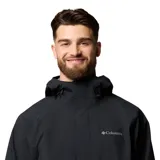 Campera impermeable y transpirable Columbia modelo Earth Explorer II Omni-Tech, de color negro, con capucha ajustable, cierre frontal con solapa, bolsillos con cremallera y puños ajustables.