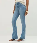 Pantalón bootcut de tiro alto confeccionado en jean de algodón con elastano. Presenta trabillas en la cintura, cierre frontal con botón, bolsillos clásicos con bolsillo reloj y bajo acampanado.
