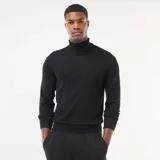 Sweater de cuello alto liso, de manga larga con puños y ruedo acanalados.