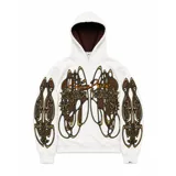 Hoodie oversize de color blanco con estampado artístico en tonos marrones y dorados en el pecho y las mangas. Presenta un forro interior de capucha en tejido marrón texturizado y costuras reforzadas.