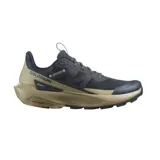 Championes de trail running Salomon modelo Elixir Activ, con diseño técnico en combinación de colores azul marino y beige. Presentan suela con tecnología Contagrip para mayor tracción y chasis activo para estabilidad.