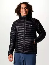 Campera puffer ultraligera Mountain Hardwear, modelo Ghost Whisperer, color negro. Confeccionada en tejido ripstop reciclado con aislamiento de plumón de 800 hilos. Cuenta con capucha, cierre frontal completo, dos bolsillos laterales con cremallera y diseño altamente compactable.