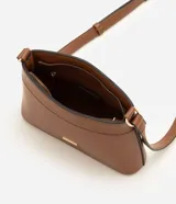 Cartera bandolera pequeña color beige con ribetes marrones, de la marca Satinato. Presenta cierre de cremallera, asa larga ajustable y detalle de placa metálica dorada con el logo en el frente.
