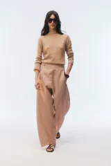 Sweater de tejido de punto color tostado, con calce al cuerpo, mangas largas y escote redondo.