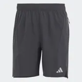 Short de entrenamiento Adidas HIIT HEAT.RDY, color gris oscuro (carbón), de corte ajustado y flexible, con cintura elástica y cordón. Presenta tejido texturizado, paneles de malla, bolsillos delanteros con cremallera y detalles reflectantes, incluyendo el logo de las tres barras en la parte inferior.