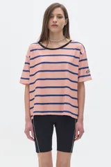 Remera oversized de rib a rayas horizontales color salmón y azul marino, con cuello redondo negro y mangas cortas.