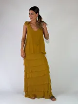 Top de viscosa color marrón tostado, sin mangas, con escote redondo y detalle de lazos para anudar en los hombros. Presenta un diseño de capas con volados en el ruedo.