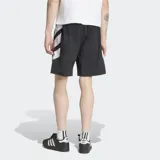 Short Adidas Adicolor Double Blocked de color negro, confeccionado en tejido ripstop. Presenta un diseño holgado, bolsillos laterales, cierre de cremallera, el logo del Trifolio bordado y detalles gráficos de franjas blancas en el lateral.
