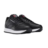 Championes Reebok de cuero negro con suela ondulada blanca.