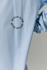 Remerón celeste de manga larga con cuello redondo y puños acanalados. Estampa en serigrafía en el frente y la espalda con la inscripción "Active Club R11".