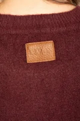 Sweater de punto con textura acanalada, cuello redondo y mangas largas. Presenta un diseño de calce holgado con ruedo redondeado y aberturas laterales.