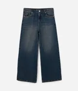 Pantalón de jean con corte baggy, de tiro alto y pierna ancha. Presenta un diseño de estilo vintage con acabado desgastado y trabillas en la cintura.