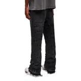 Pantalón de jean negro de corte flare, con diseño geométrico fruncido mediante pinzas en toda su superficie.