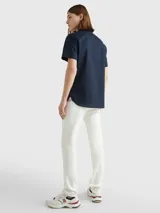Camisa de manga corta Tommy Hilfiger confeccionada en popelín de algodón, con cuello abotonado y cierre frontal de botones. Presenta un corte regular y el logo de la marca bordado en el pecho.