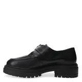Zapato tipo mocasín de charol negro con suela track gruesa y cierre mediante hebilla metálica en el empeine.