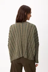 Sweater de punto con diseño de rayas verticales en relieve y textura trenzada, color terracota y beige. Presenta cuello redondo, corte holgado y diseño cropped.
