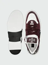Zapatillas bajas Philipp Plein Phantom Cocco, modelo de diseño robusto en color bordó y blanco, con detalles en negro. Cuentan con cordones, suela de goma blanca y apliques metálicos y de goma con el logotipo de la marca.