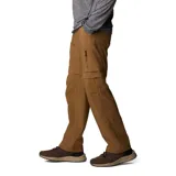 Pantalón convertible de senderismo color marrón, con diseño funcional que permite desmontar las perneras mediante cremalleras para convertirlo en short. Cuenta con bolsillos cargo laterales, bolsillos de seguridad con cierre y cinturón integrado.