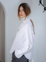 Camisa blanca de algodón con cuello alto y lazo desmontable.