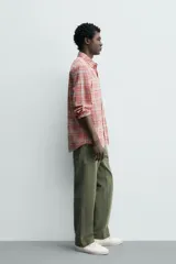Camisa de manga larga relaxed fit a cuadros en tonos rosados, rojos y celestes. Cuenta con cuello abotonado, bolsillo de parche en el pecho y cierre frontal con botones.