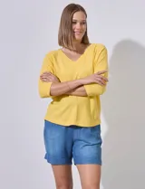 Buzo amarillo de algodón marca Ninety, con escote en V y mangas 3/4. Tejido fino con pespuntes verticales en el centro del frente y la espalda.