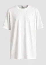 Remeron de corte clásico con cuello redondo y mangas cortas, confeccionado en tela blanca con detalles brillantes distribuidos por toda la prenda.