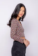 Top corto de tejido con estampa retro, manga larga y cuello redondo.