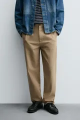 Pantalón chino de corte recto confeccionado en tejido ligero de algodón con estructura canvas. Presenta bolsillos frontales, bolsillos traseros de vivo y cierre frontal con cremallera y botón.