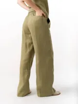 Pantalón de lino de corte holgado y tiro ajustable, con cintura elástica y cordón. Presenta bolsillos laterales y un bolsillo trasero.