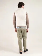 Chaleco gris acolchado para hombre, confeccionado en nylon reciclado repelente al agua, con cierre de cremallera, sisa elástica y logo engomado en el pecho.