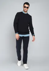 Sweater de punto trenzado color azul marino, con cuello redondo y mangas largas.