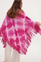 Chaleco tejido de punto fucsia con estampado tie-dye blanco y flecos en el ruedo.