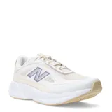 Championes New Balance modelo Training Cat, de diseño deportivo en tonos blanco y beige con detalles en lila. Presentan una estructura de malla transpirable con refuerzos sintéticos, el logo 'N' característico en el lateral y una suela de goma con amortiguación.