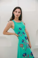 Vestido largo color verde agua con estampado de flores azules y rojas.