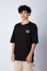 Remera blanca de corte oversize con mangas cortas y cuello redondo. Estampado pequeño en el frente con letras verdes.