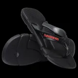 Sandalias tipo ojota Havaianas modelo Power 2.0, color negro con detalles en azul oscuro en las tiras. Presentan un diseño ergonómico con textura antideslizante en la base y tiras con relieve decorativo.