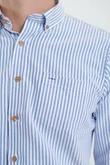 Camisa de manga larga con estampado de rayas verticales finas en tonos gris y blanco. Presenta cuello button-down, bolsillo frontal en el pecho y botones de madera.