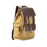 Mochila de tela canvas color negro con solapa y detalles en cuero sintético marrón. Presenta un cierre superior tipo marinero con cordón ajustable, solapa principal con correas y hebillas, y un bolsillo frontal con solapa. Posee bolsillos laterales con cierre metálico y correas de hombro ajustables.