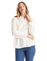 Blusa de algodón con diseño de broderie floral, cuello a la base, cierre frontal con botones y mangas largas amplias.