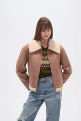 Campera estilo aviador color marrón claro, con cuello y forro de corderito color beige. Presenta cierre frontal y puños y ruedo con terminación de corderito.