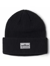 Gorro tipo beanie de tejido acanalado en color negro, con vuelta en el borde y parche rectangular con logo de la marca Columbia en la parte frontal.