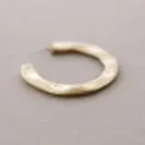 Par de argollas doradas de metal con textura martelé.