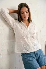 Camisa de manga larga confeccionada en algodón con diseño de broderie floral. Presenta cuello clásico, cierre frontal con botones y corte al cuerpo.