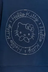 Sudadera de cuello redondo y manga larga en color azul marino. Presenta un estampado frontal con el texto 'Hello Kitty' decorado con pedrería brillante y el icónico lazo del personaje. Cuenta con puños y bajo en tejido rib a tono.