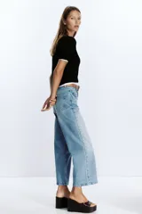 Jeans culotte de tiro alto color celeste, con corte wide leg y largo cropped. Incluye cinturón marrón de cuero.