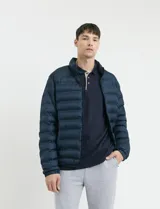 Campera capitoneada de poliéster con cierre frontal al tono y bolsillos laterales con cierre invisible.