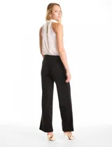Pantalón de corte wide leg en color gris, con cintura alta y detalle de pretina prolongada con hebilla metálica lateral. Presenta costuras verticales frontales y cierre con gancho interno.